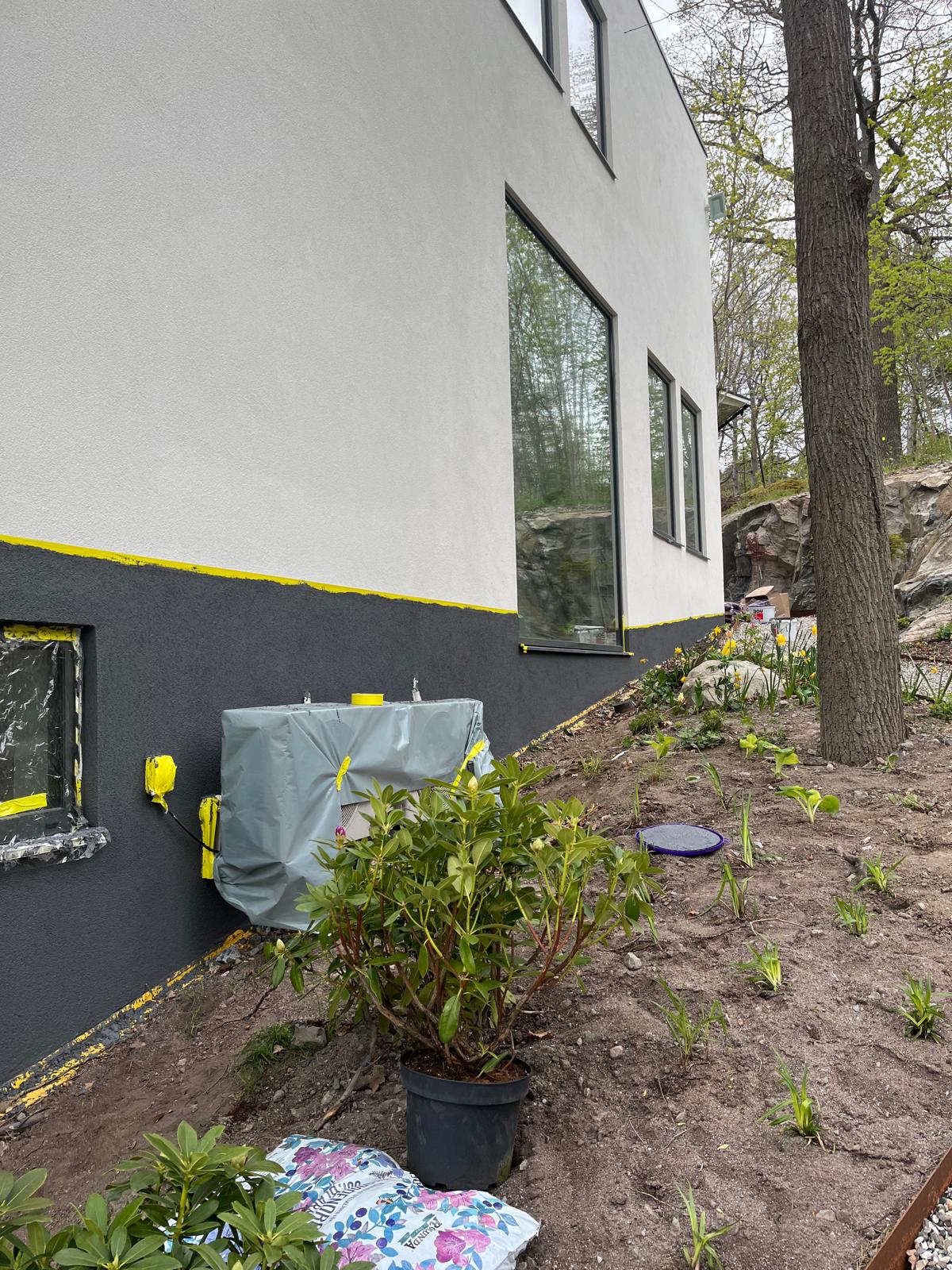 Nymålad vit och mörkgrå fasad på modern villa